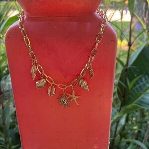 Elegant Gold Charm Necklace with Nautical Accents